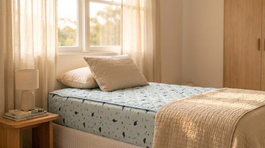 Sunlit Australian kids bedroom with a Rudie Baby whales-print leakproof fitted sheet on a single bed