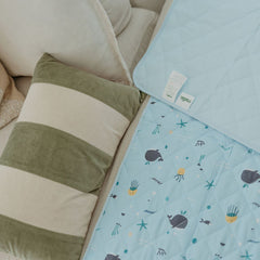 Rudie Baby leakproof fitted sheet in Whales print on beige couch